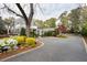 Circular driveway leading to a stately home, surrounded by vibrant landscaping and mature trees, showcasing elegant curb appeal at 478 Huger St, Charleston, SC 29403