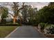 Long driveway leading to a gated entrance with lush landscaping and mature trees at 478 Huger St, Charleston, SC 29403