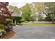Spacious driveway leading to a stone home with lush greenery, showcasing ample parking and beautiful landscaping at 478 Huger St, Charleston, SC 29403