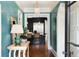 Elegant entryway with blue walls, a hardwood floor, and a view into a kitchen with black cabinets and a white countertop at 478 Huger St, Charleston, SC 29403