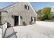 A spacious balcony with seating area outside a beautiful gray stone home at 478 Huger St, Charleston, SC 29403
