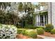 Picturesque stone residence complemented by vibrant azaleas and lush greenery, showcasing a harmonious blend of nature and architecture at 478 Huger St, Charleston, SC 29403