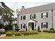 Stone home showcasing meticulous landscaping, a decorative fountain, and elegant architectural details, creating a timeless appeal at 478 Huger St, Charleston, SC 29403