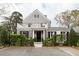Charming stone home featuring a balcony, black shutters, and lush landscaping, exuding curb appeal at 478 Huger St, Charleston, SC 29403