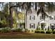 Stone-clad home featuring manicured landscaping and mature trees at 478 Huger St, Charleston, SC 29403