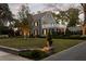 Beautiful stone home with upper balcony, mature trees, and manicured front yard at 478 Huger St, Charleston, SC 29403