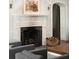 Living room featuring a fireplace, white mantle, framed art, and archway to the next room at 478 Huger St, Charleston, SC 29403
