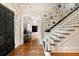 Entryway with hardwood floors, stairs, dark trim, and framed Gathering photos at 478 Huger St, Charleston, SC 29403