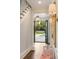 Bright foyer with staircase and view of the pool through open doors at the end of the hallway at 478 Huger St, Charleston, SC 29403