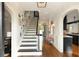 Inviting foyer with a staircase, hardwood floors, and a glimpse of the backyard pool at 478 Huger St, Charleston, SC 29403
