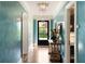 Elegant foyer boasts beautiful aqua blue walls, hardwood floors, and a view to the exterior at 478 Huger St, Charleston, SC 29403
