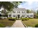 Elegant stone facade home with manicured lawn, symmetrical shrubbery, and tiled roof at 478 Huger St, Charleston, SC 29403