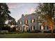 Charming stone home with black shutters, manicured lawn, and mature trees at 478 Huger St, Charleston, SC 29403