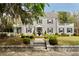 Charming stone-clad home with manicured landscaping, a fountain, and mature trees at 478 Huger St, Charleston, SC 29403