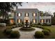 Beautiful home with a water fountain, surrounded by meticulously manicured landscaping and a stone walkway at 478 Huger St, Charleston, SC 29403