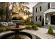 Beautiful home featuring a stone facade, manicured lawn, a water fountain, and professionally landscaped yard at 478 Huger St, Charleston, SC 29403