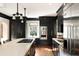 Stylish kitchen showcasing dark cabinets, stainless steel appliances, and a large island with marble countertops at 478 Huger St, Charleston, SC 29403