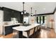 Gourmet kitchen with a large island, barstool seating, modern appliances, and access to an outdoor pool area at 478 Huger St, Charleston, SC 29403