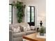 Cozy living room featuring large windows, a comfortable sofa with decorative pillows, and an elegant black door at 478 Huger St, Charleston, SC 29403