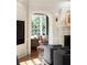 Sitting room view through an arched doorway, showing a couch, chair, and window at 478 Huger St, Charleston, SC 29403