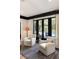 Cozy seating area with large black windows offering a view of the pool and backyard at 478 Huger St, Charleston, SC 29403