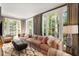 Bright and airy living room with large windows, plush seating, elegant curtains, and a decorative rug at 478 Huger St, Charleston, SC 29403