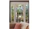 Bright and sunny view of exterior foliage seen through large windows in the living room at 478 Huger St, Charleston, SC 29403
