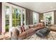 Bright and airy living room with large windows, plush seating, elegant curtains, and a decorative rug at 478 Huger St, Charleston, SC 29403