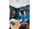 Stylish office with blue walls, a wooden desk, a zebra rug, and an interesting portrait at 478 Huger St, Charleston, SC 29403