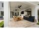 Covered outdoor kitchen and dining area with stone flooring and ceiling fans for comfortable entertaining at 478 Huger St, Charleston, SC 29403