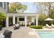 Luxurious outdoor living space with a pool, dining area, kitchen, and comfortable seating at 478 Huger St, Charleston, SC 29403