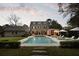 Stunning backyard with a sparkling pool, lounge chairs, and lush landscaping perfect for relaxation at 478 Huger St, Charleston, SC 29403