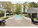 Beautiful backyard pool with a hot tub, lounge chairs, and lush landscaping on a sunny day at 478 Huger St, Charleston, SC 29403