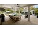 Inviting pool area featuring lounge chairs, a large dining table, outdoor kitchen, and a separate garage at 478 Huger St, Charleston, SC 29403