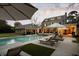Spacious backyard with a swimming pool, sun loungers, and elegant stone details for outdoor relaxation at 478 Huger St, Charleston, SC 29403