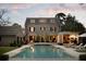 Backyard view showcasing a sparkling pool and patio, surrounded by a well-maintained stone house at 478 Huger St, Charleston, SC 29403
