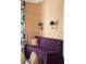Cozy sitting area with a plush purple sofa and stylish wall sconces at 478 Huger St, Charleston, SC 29403