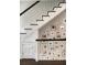 Traditional staircase featuring a white banister, dark wood trim, and a gallery wall adorned with framed photographs at 478 Huger St, Charleston, SC 29403
