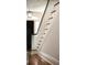 Elegant staircase with white spindles and black handrail, leading to the upper level at 478 Huger St, Charleston, SC 29403