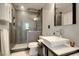 Modern bathroom with a glass-enclosed shower, vessel sink, and sleek gray tile at 5 Kracke St # A, Charleston, SC 29403