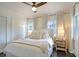Bright bedroom featuring hardwood floors, neutral decor, two windows, and a cozy white comforter at 5 Kracke St # A, Charleston, SC 29403