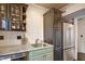 Elegant kitchen with a stainless steel fridge, dark wood cabinets and stylish subway tile backsplash at 5 Kracke St # A, Charleston, SC 29403