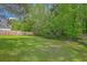 Secluded backyard with lush green lawn and wooded backdrop at 5033 Thornton Dr, Summerville, SC 29485
