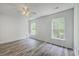 Bedroom featuring modern ceiling fan, two windows, and wood-look flooring at 5033 Thornton Dr, Summerville, SC 29485