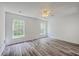 Bright bedroom features modern ceiling fan, two windows and wood-look flooring at 5033 Thornton Dr, Summerville, SC 29485