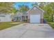 Inviting one-story home with a well-manicured lawn, concrete driveway, and attached garage, offering comfortable living at 5033 Thornton Dr, Summerville, SC 29485