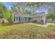 Traditional single-story home with tidy landscaping, a concrete driveway, and a cozy front entrance at 5033 Thornton Dr, Summerville, SC 29485