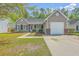 Charming single-story home featuring a well-maintained lawn, neutral siding, and an attached one-car garage at 5033 Thornton Dr, Summerville, SC 29485