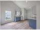 Bright kitchen with wood-look floors, gray lower cabinets, white upper cabinets and stainless steel sink at 5033 Thornton Dr, Summerville, SC 29485