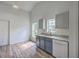 Bright kitchen features gray base cabinets with white appliances and wood-look floors at 5033 Thornton Dr, Summerville, SC 29485
